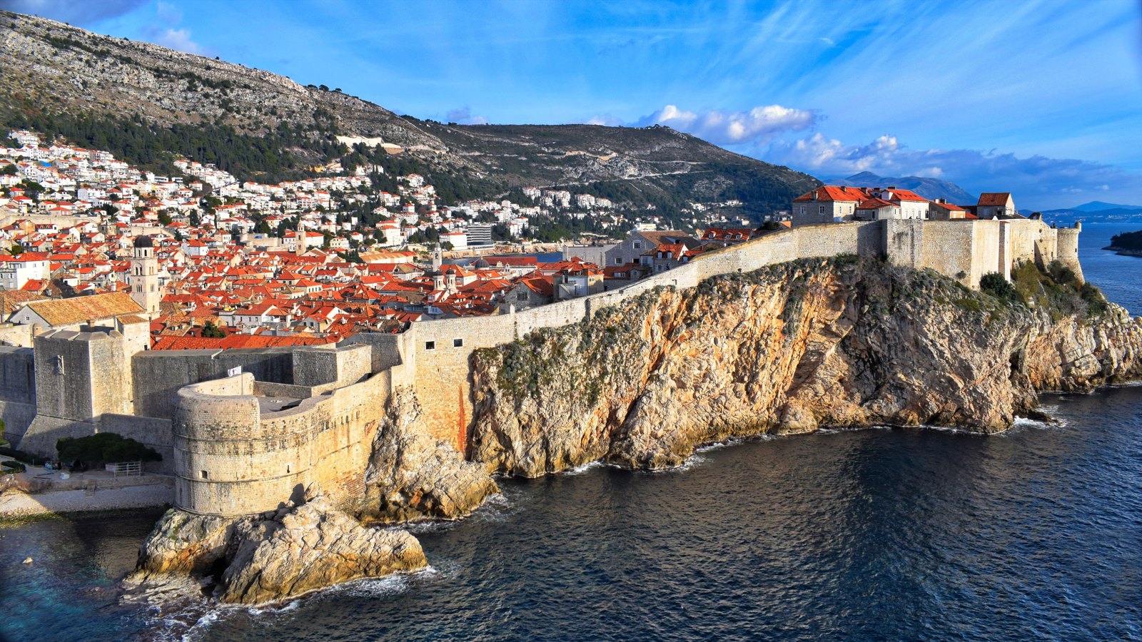 Dubrovnik’s historic stone walls, red roofs, and the blue Adriatic Sea